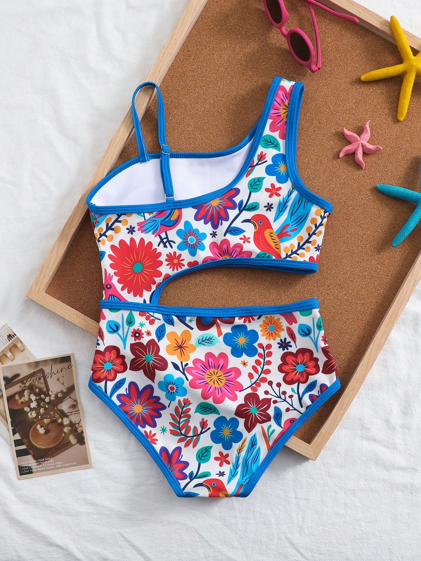 Tween girls one-piece swimsuit featuring an asymmetric neckline, pendant decor, plain design, wireless bra, high-cut bottom, and medium-stretch fabric.