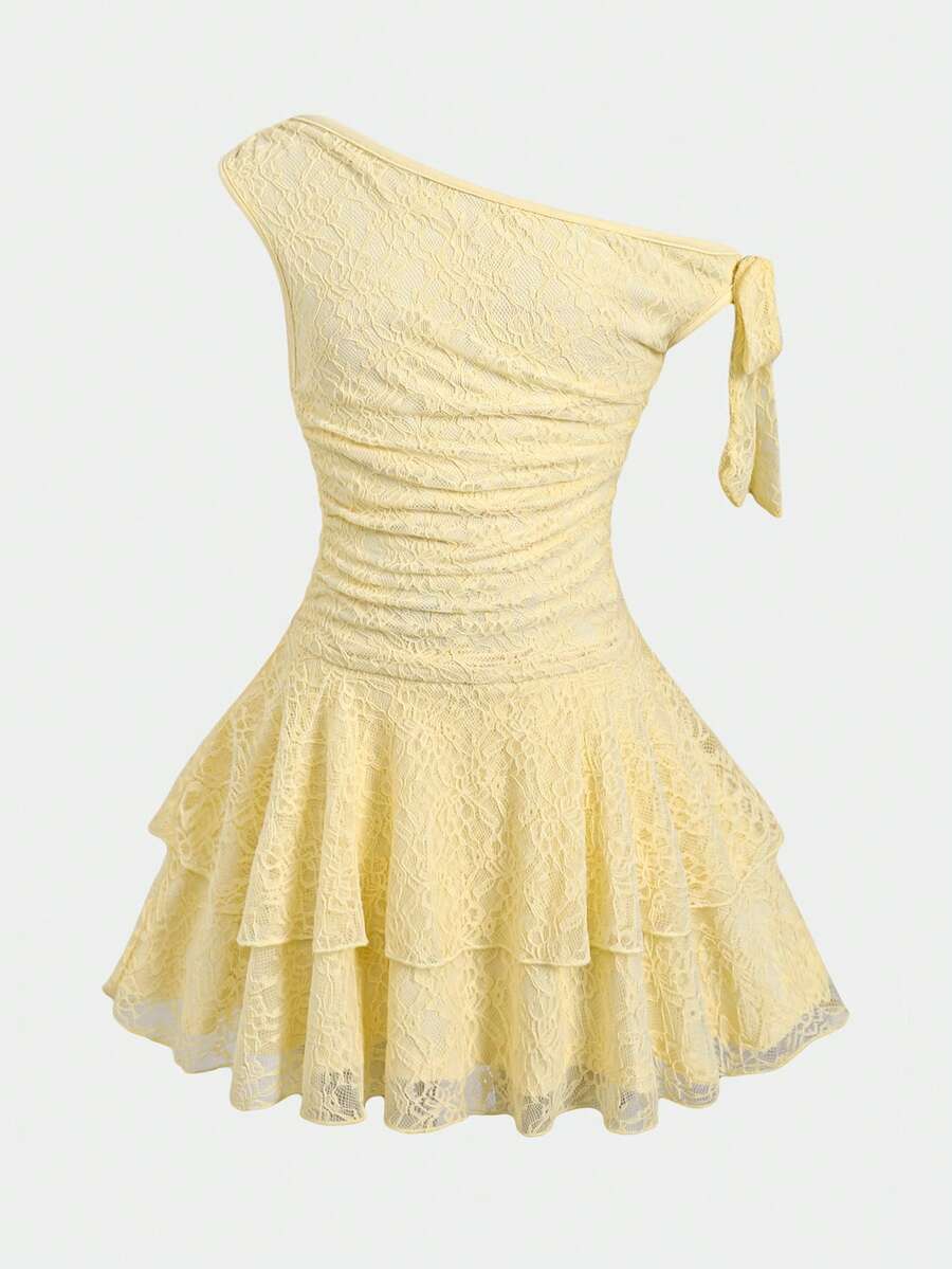 Tween girl wearing an apricot asymmetrical tiered sleeveless party dress with an A-line silhouette.