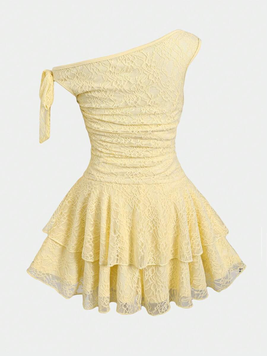 Tween girl wearing an apricot asymmetrical tiered sleeveless party dress with an A-line silhouette.