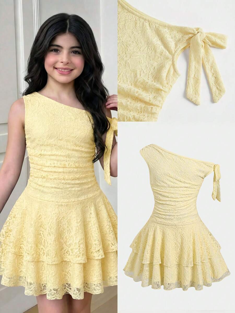 Tween girl wearing an apricot asymmetrical tiered sleeveless party dress with an A-line silhouette.