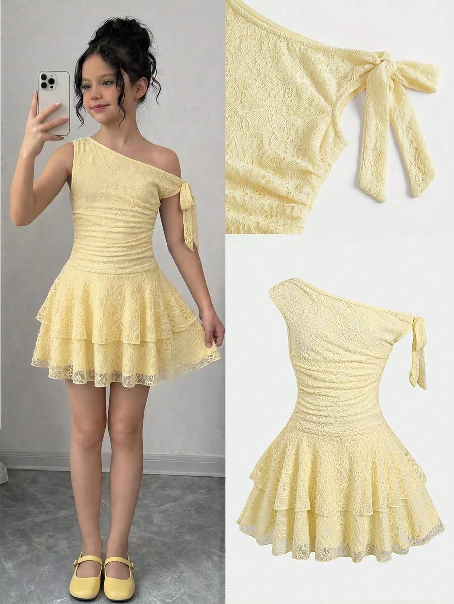 Tween girl wearing an apricot asymmetrical tiered sleeveless party dress with an A-line silhouette.
