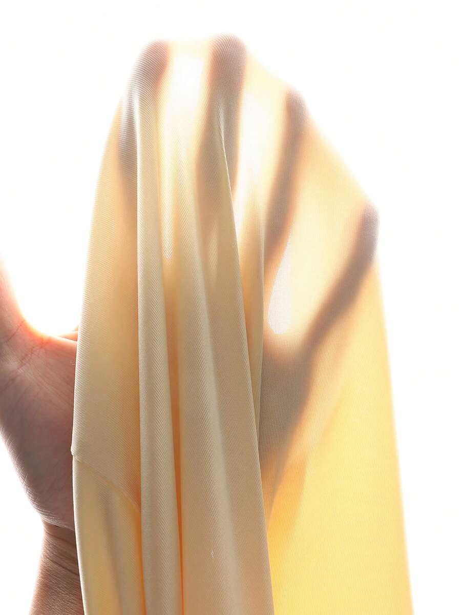 Tween girl wearing an apricot asymmetrical tiered sleeveless party dress with an A-line silhouette.
