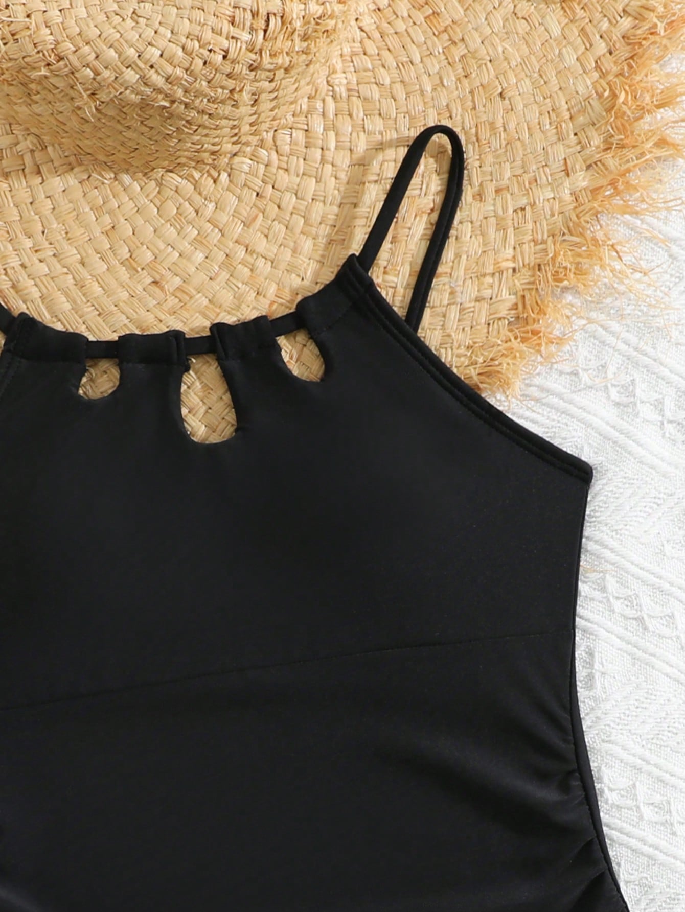 Girls black and white one-piece swimsuit set with cut-out detail, spaghetti straps, sleeveless fitted design, and matching skirt bottom for vacation swimwear.
