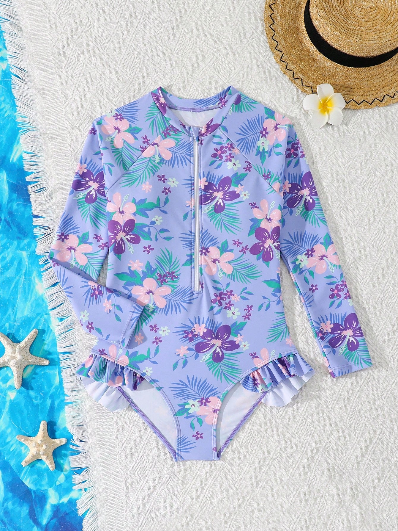 Girls one-piece swimsuit in blue with all-over leopard leaf print, ruffle detail, zipper front, high neck, and lined body for swimming and vacation.