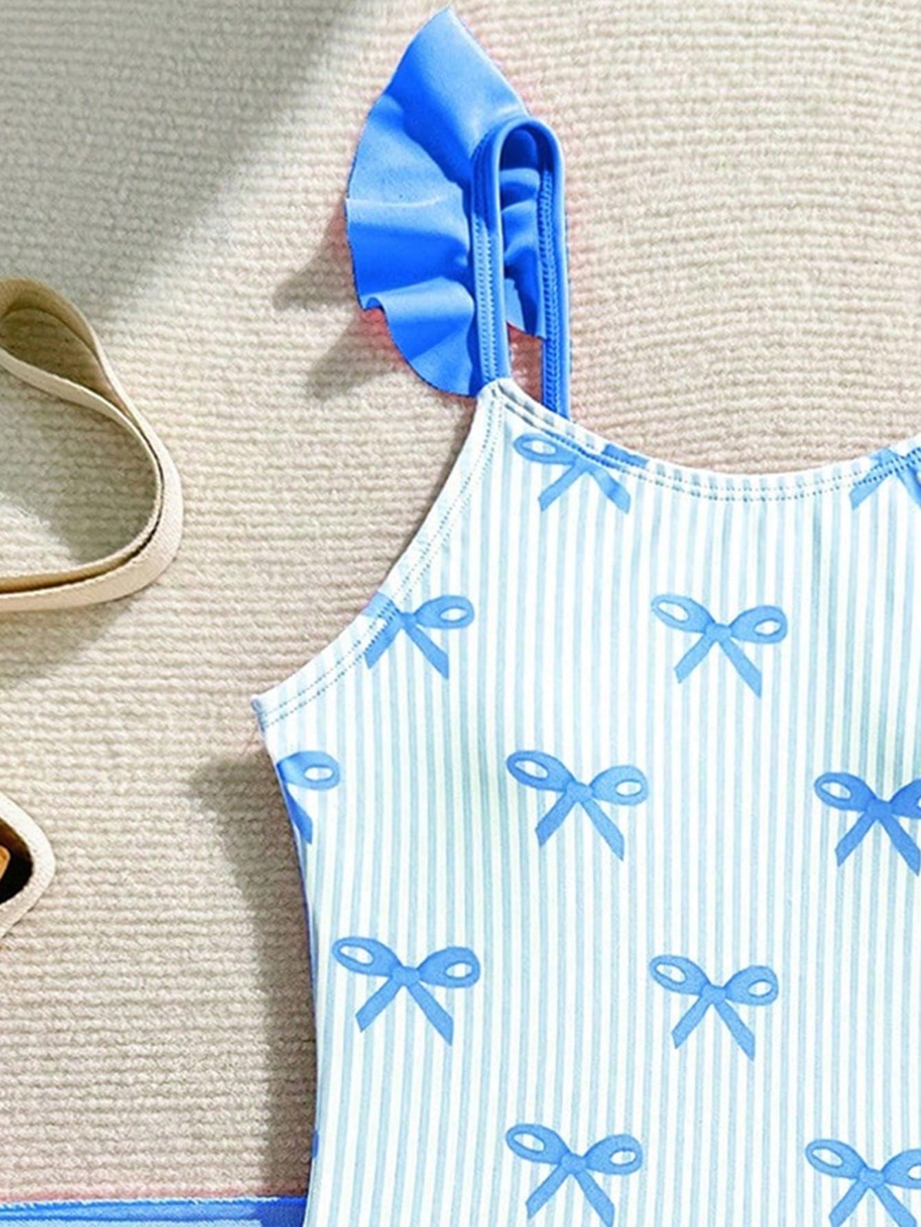 Tween girls one-piece swimsuit in leopard print with ruffle shoulder straps, scoop neckline, fitted shape, and attached ruffle hem skirt; sleeveless, mid-waist skirt bottom, and lined body for swimming, vacation, and summer beach wear.