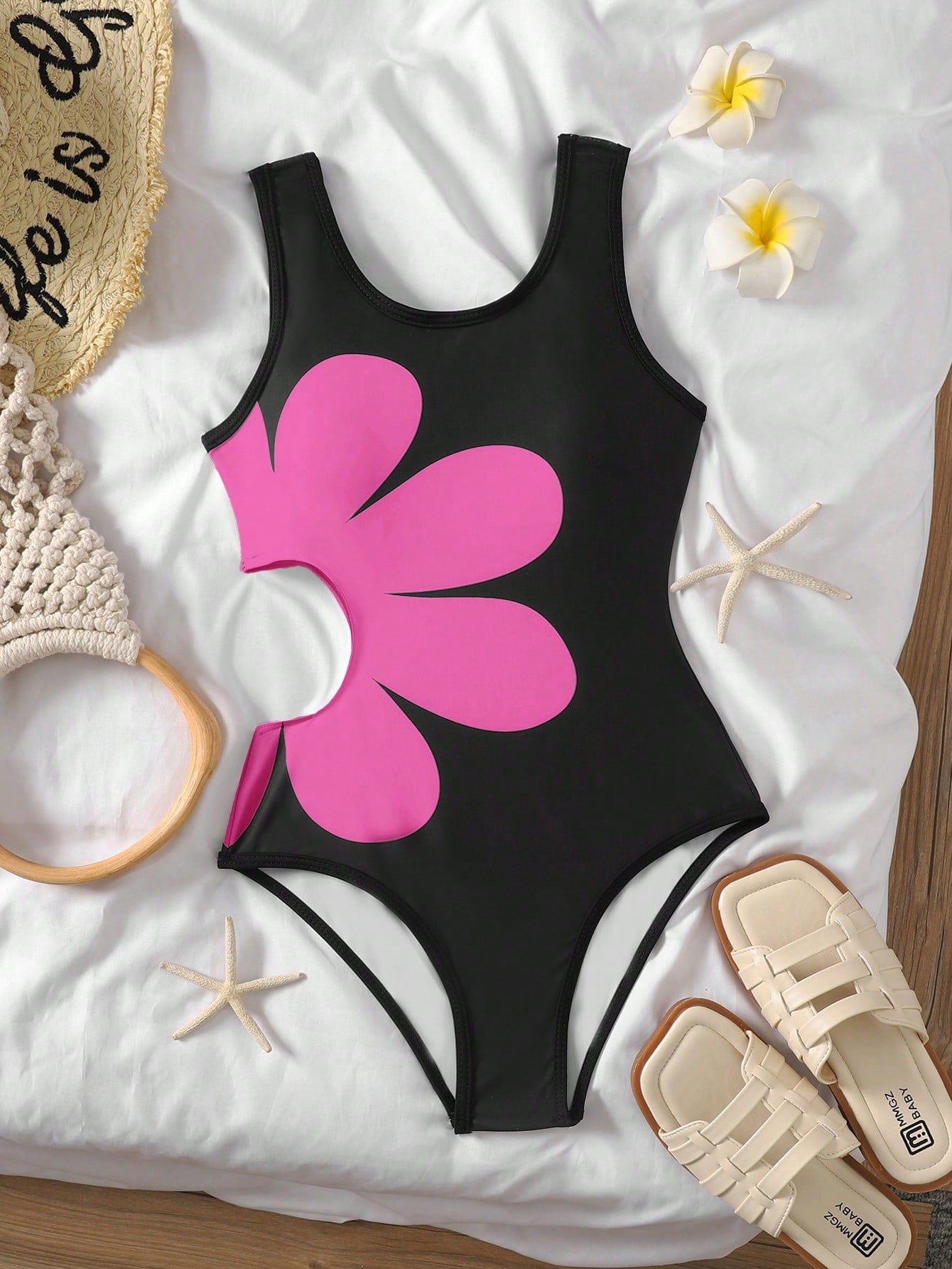 Tween girls' black and white one-piece swimsuit with striped patchwork design, scoop neck, asymmetrical cut-out detail, and fitted vacation swimwear style.