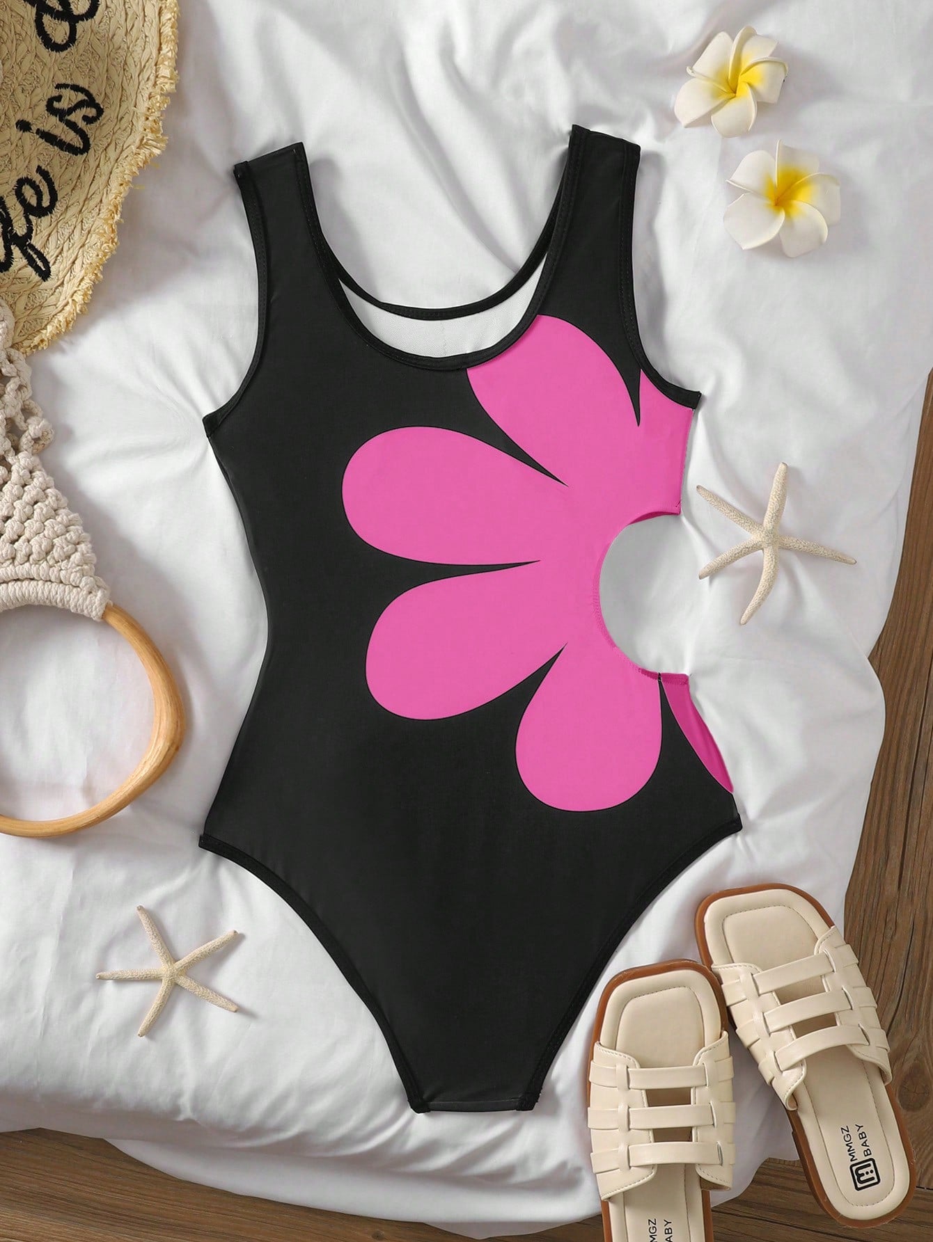 Tween girls' black and white one-piece swimsuit with striped patchwork design, scoop neck, asymmetrical cut-out detail, and fitted vacation swimwear style.