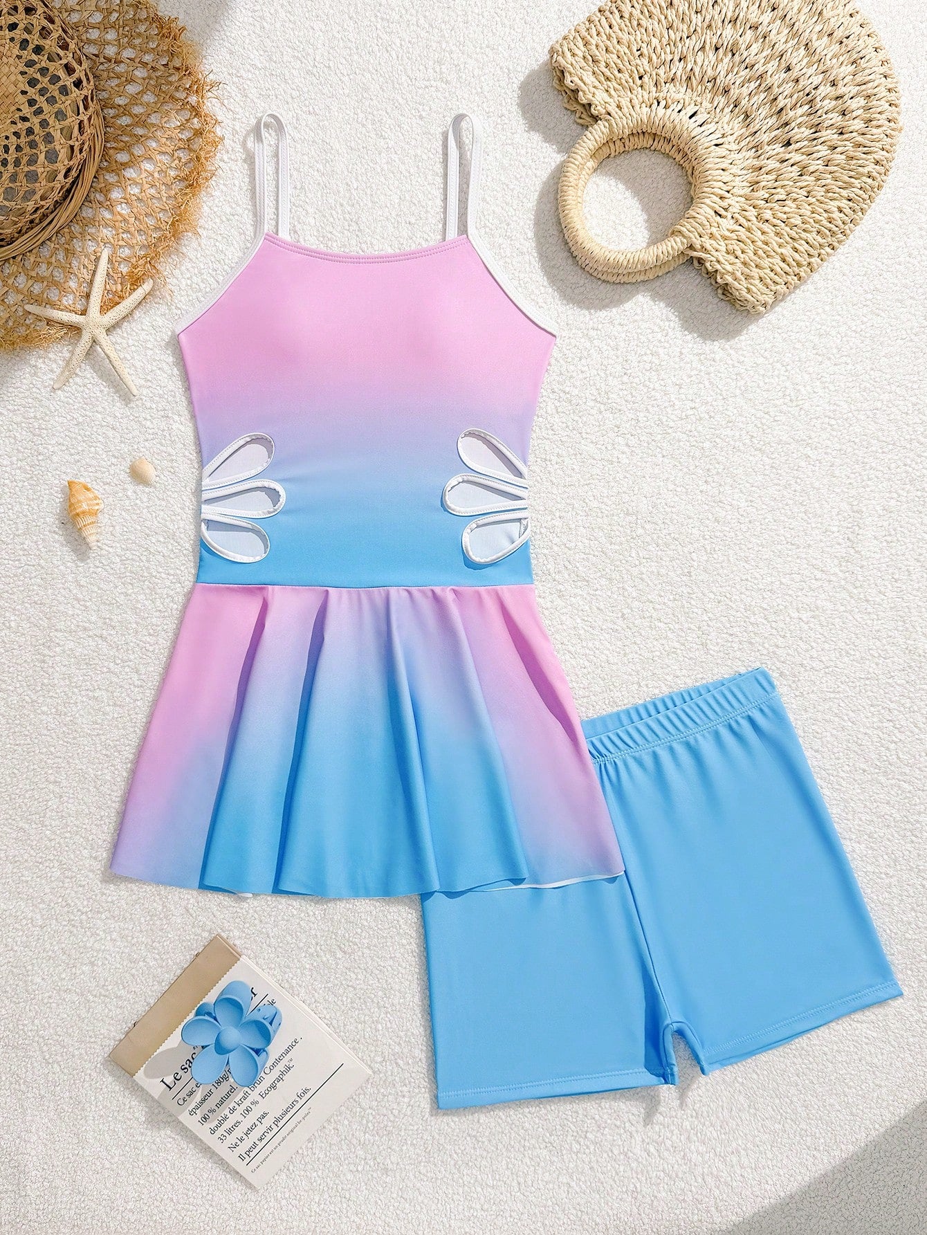 Tween girls black two-piece tankini swimwear set featuring a spaghetti strap sleeveless top with cutout detail and contrast piping, paired with short swim shorts.