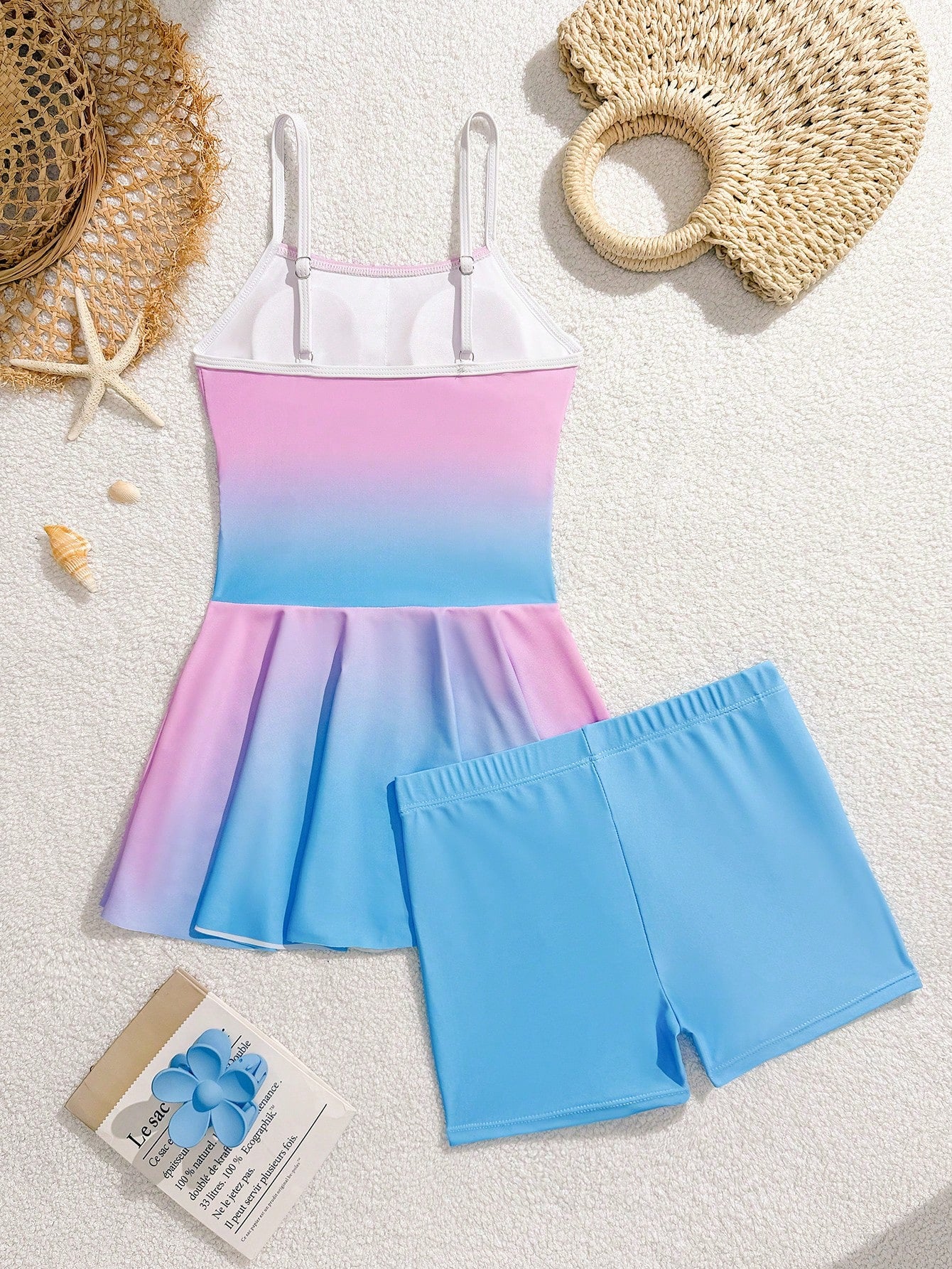 Tween girls black two-piece tankini swimwear set featuring a spaghetti strap sleeveless top with cutout detail and contrast piping, paired with short swim shorts.