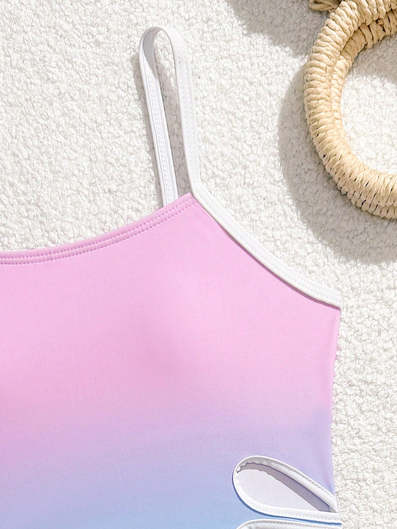 Tween girls black two-piece tankini swimwear set featuring a spaghetti strap sleeveless top with cutout detail and contrast piping, paired with short swim shorts.