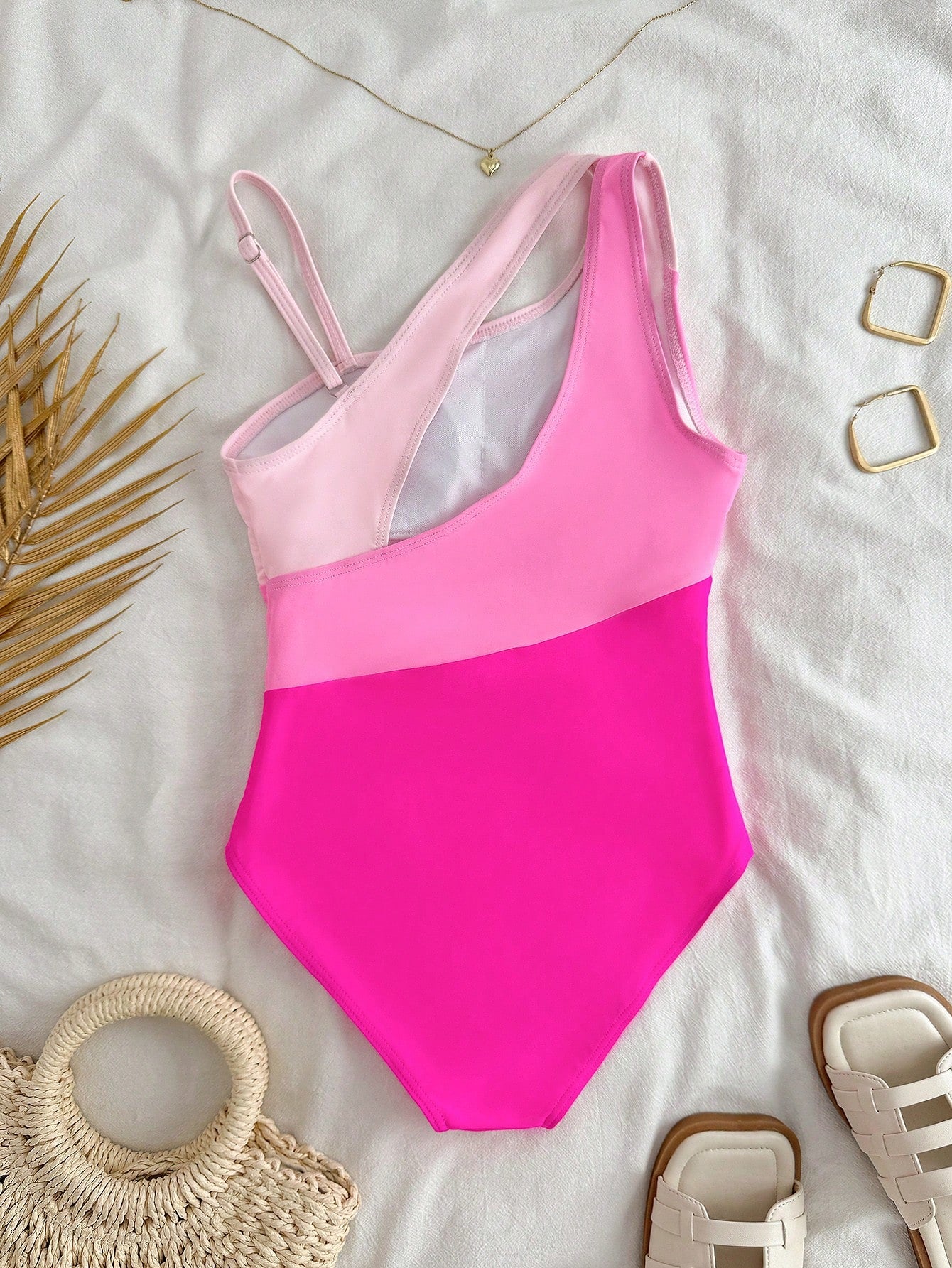 Black one-piece swimsuit for tween girls with cut out detail, spaghetti straps, high waist bottom, wireless bra, and fitted vacation swimwear style.