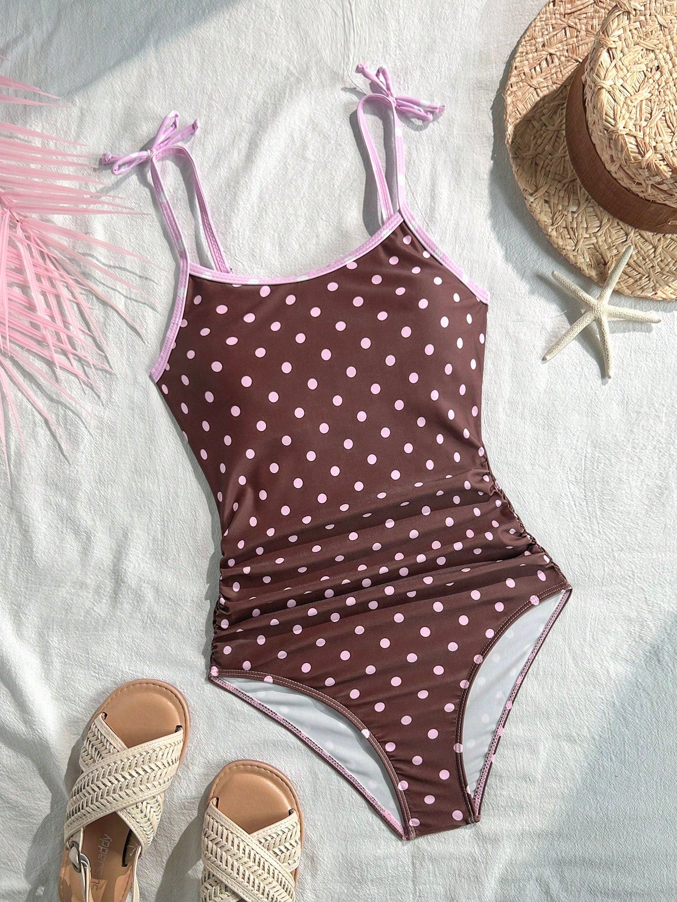 Tween girls' black and white one-piece swimsuit with striped patchwork design, scoop neck, asymmetrical cut-out detail, and fitted vacation swimwear style.