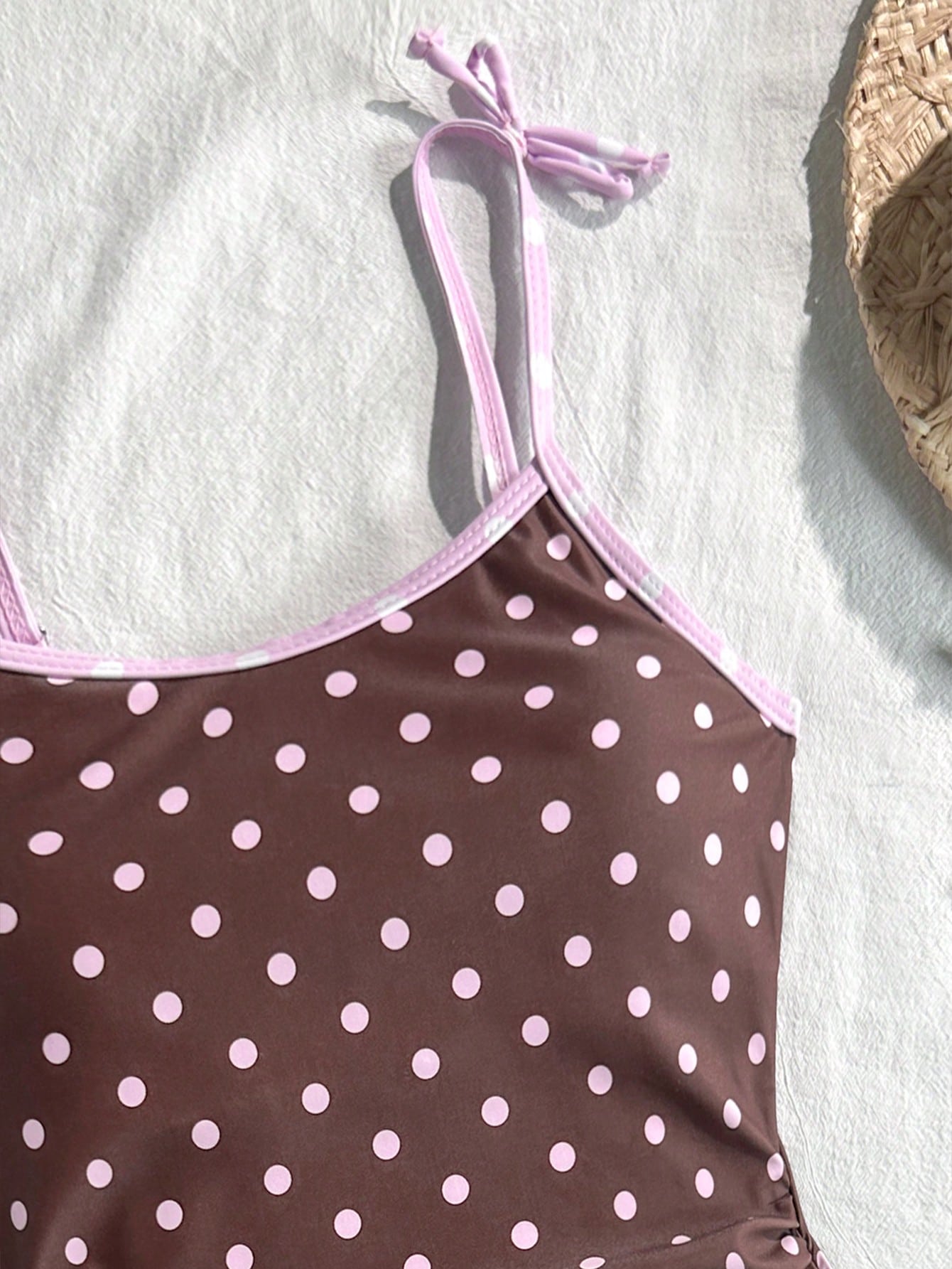 Tween girls' black and white one-piece swimsuit with striped patchwork design, scoop neck, asymmetrical cut-out detail, and fitted vacation swimwear style.