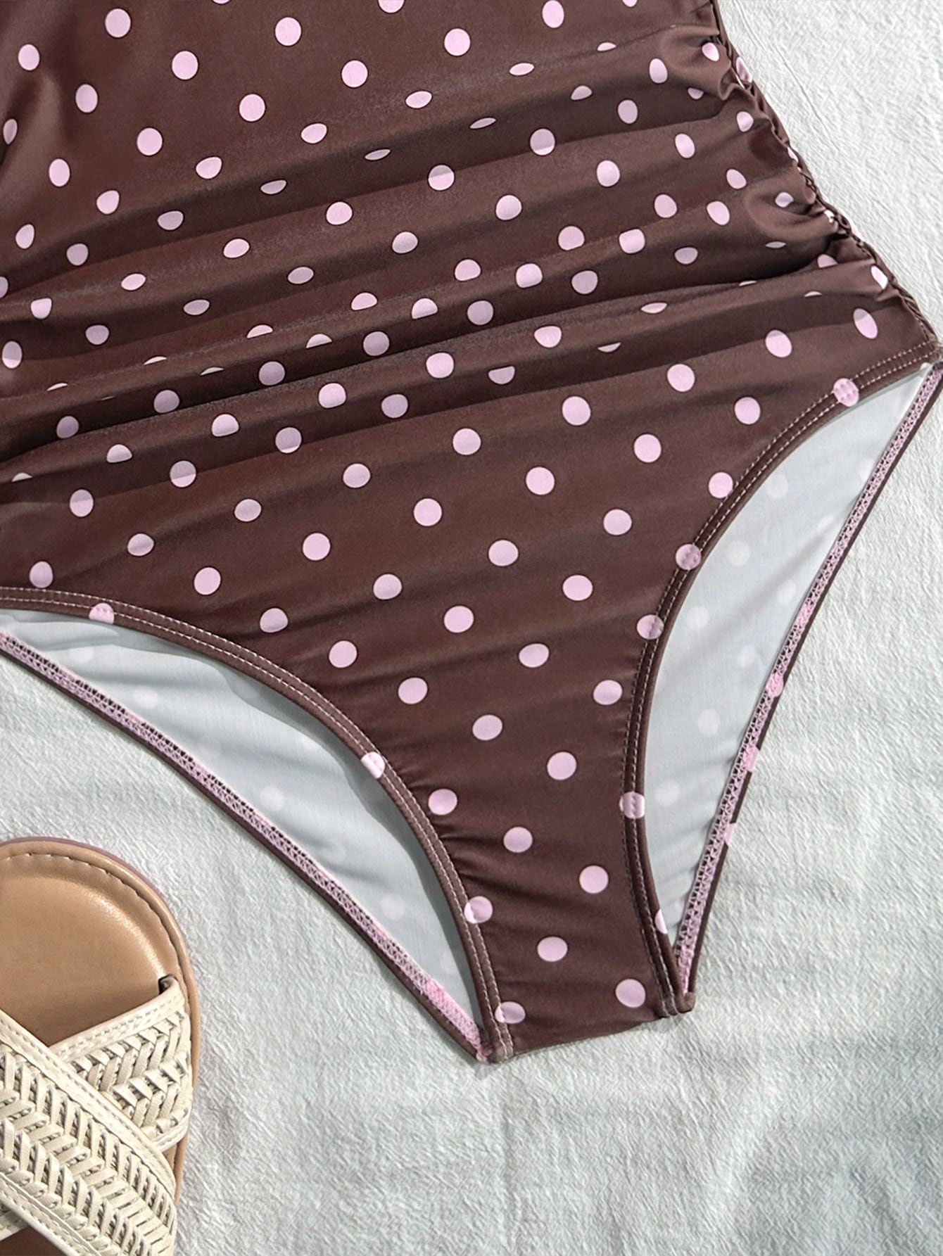 Tween girls' black and white one-piece swimsuit with striped patchwork design, scoop neck, asymmetrical cut-out detail, and fitted vacation swimwear style.
