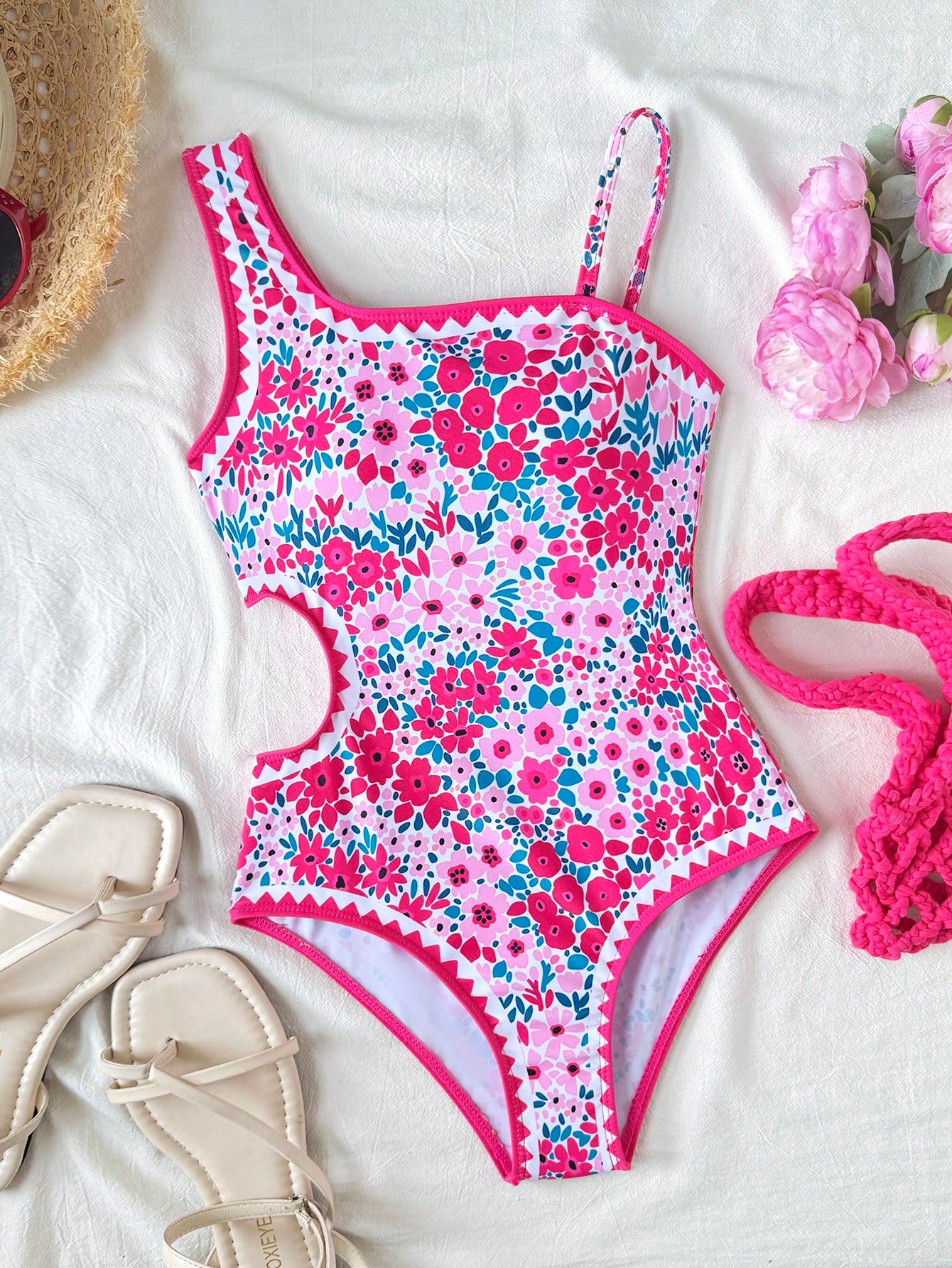 Tween girls' black and white one-piece swimsuit with striped patchwork design, scoop neck, asymmetrical cut-out detail, and fitted vacation swimwear style.
