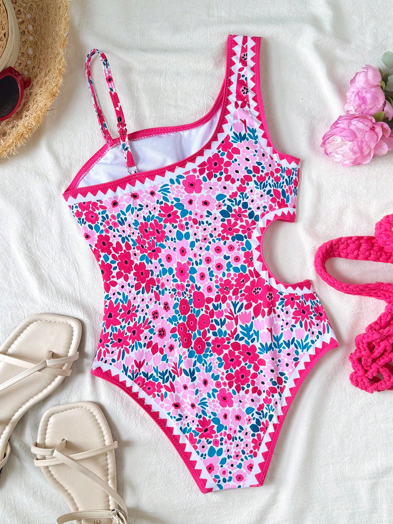 Tween girls' black and white one-piece swimsuit with striped patchwork design, scoop neck, asymmetrical cut-out detail, and fitted vacation swimwear style.
