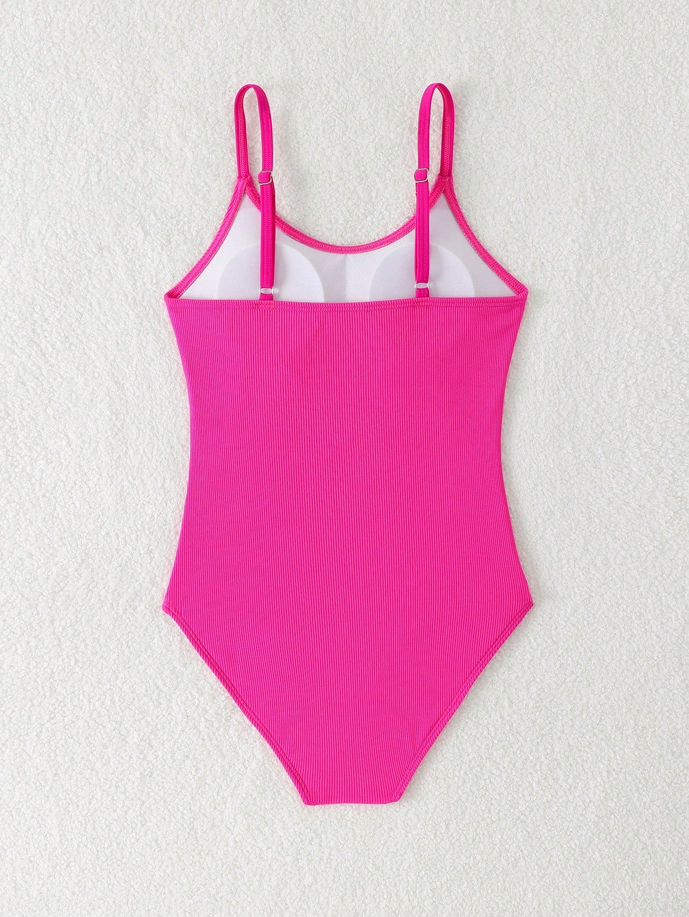 Purple rib knit one-piece swimsuit for tween girls with spaghetti straps, fitted shape, mid-waist bottom, wireless bra, and lined body.