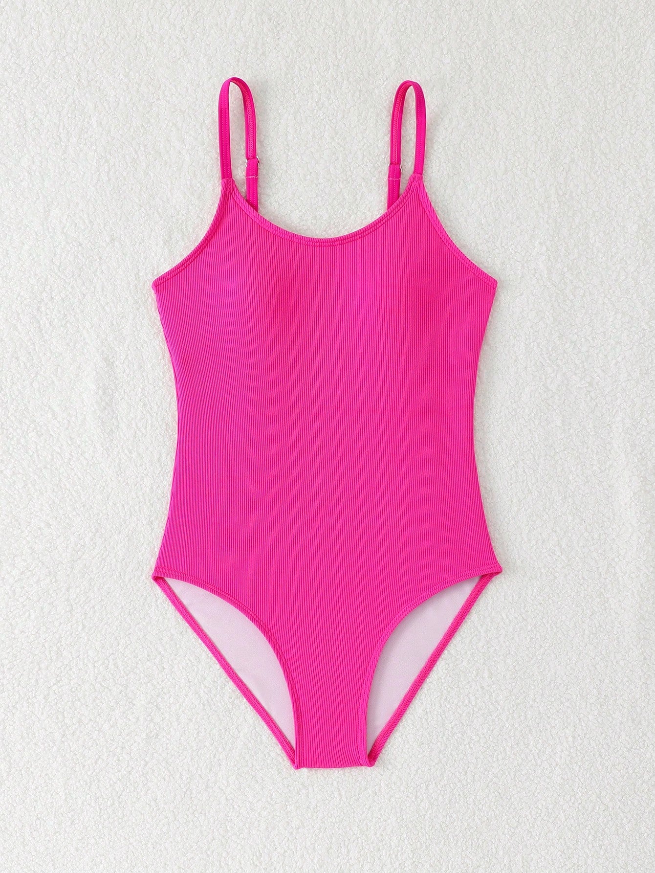 Purple rib knit one-piece swimsuit for tween girls with spaghetti straps, fitted shape, mid-waist bottom, wireless bra, and lined body.