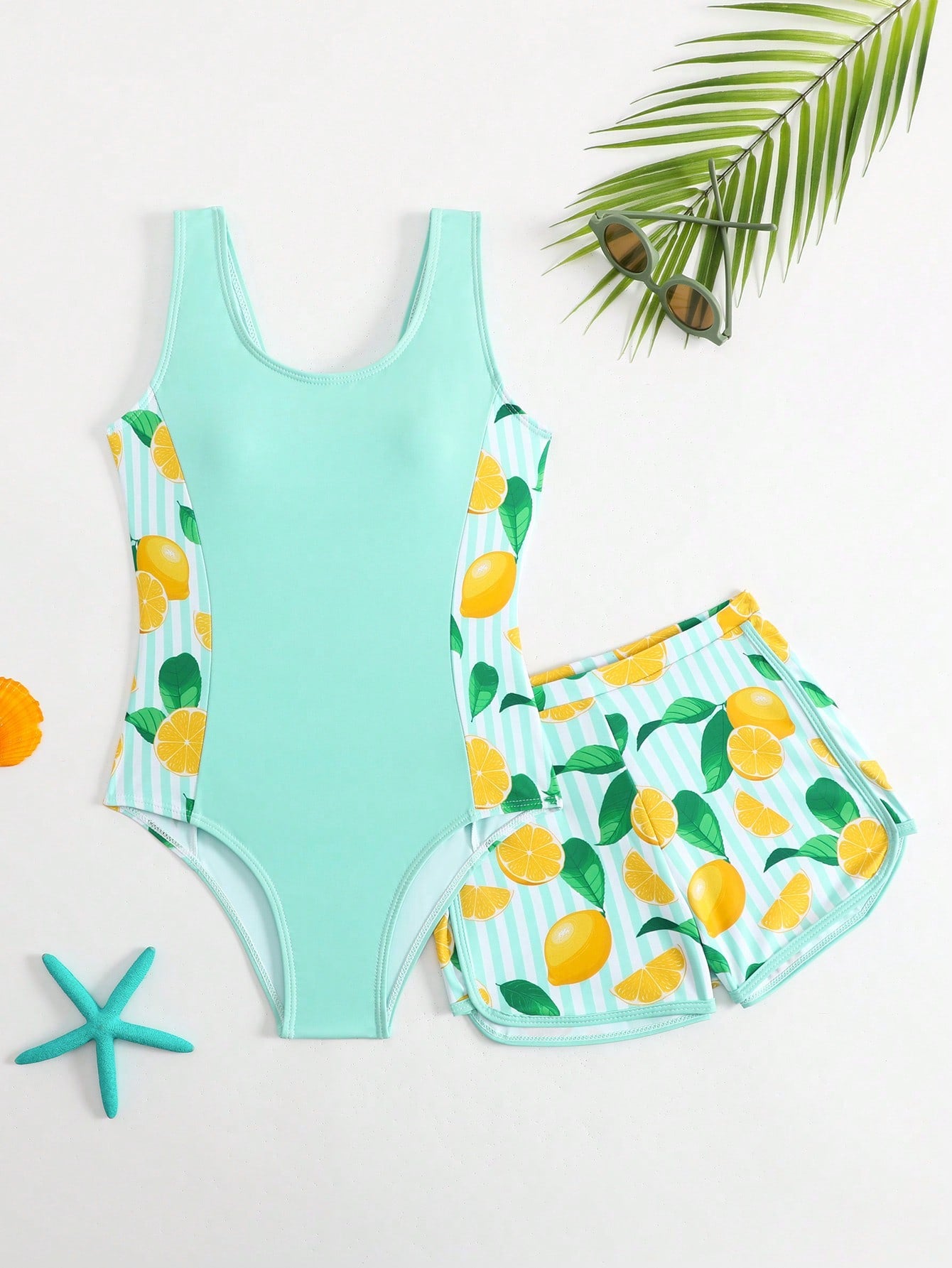 Tween girls 2-piece swimsuit set with a printed one-piece featuring ruffle trim, scoop neckline, cut-out detail, and matching shorts bottom.