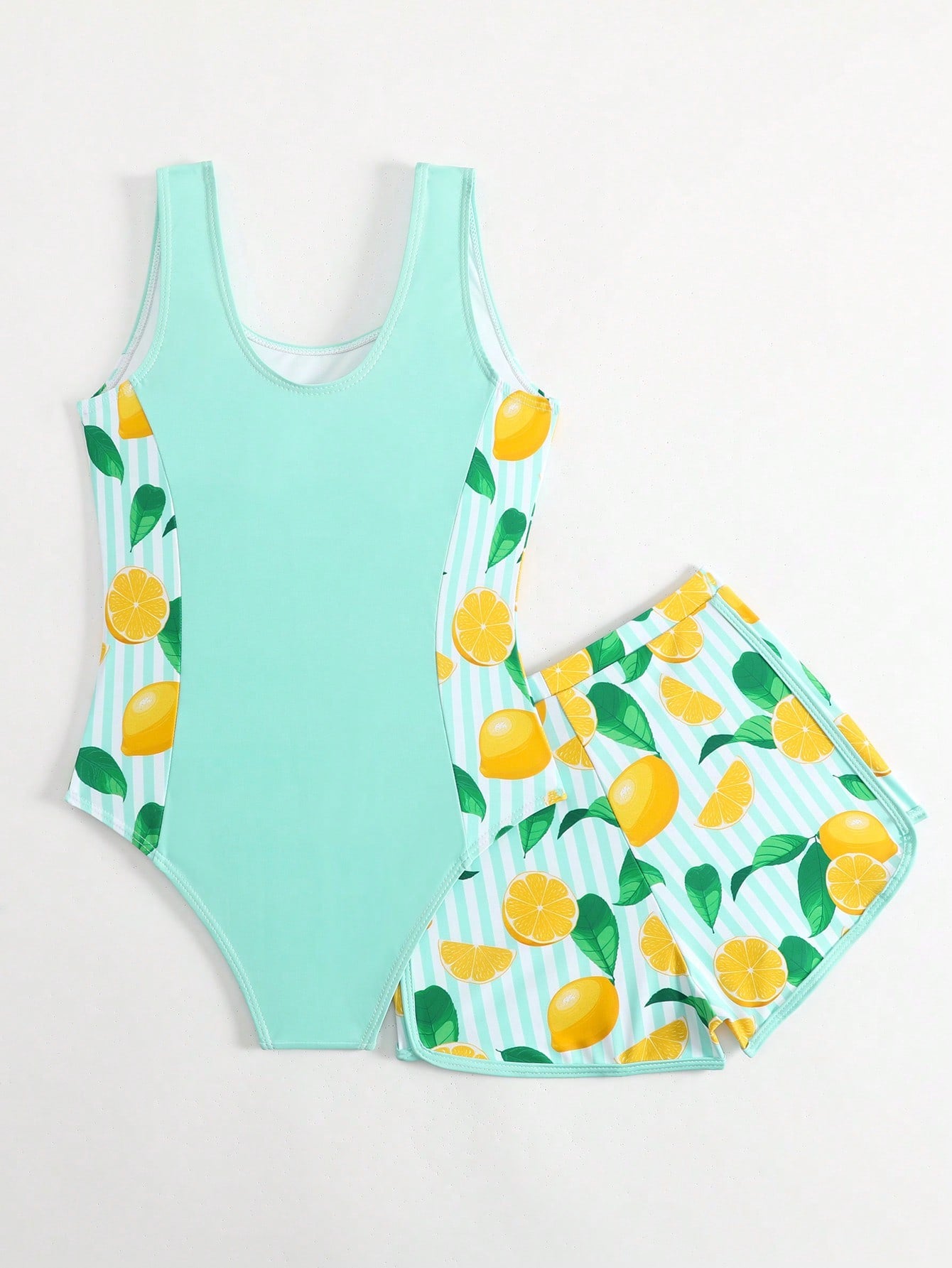 Tween girls 2-piece swimsuit set with a printed one-piece featuring ruffle trim, scoop neckline, cut-out detail, and matching shorts bottom.