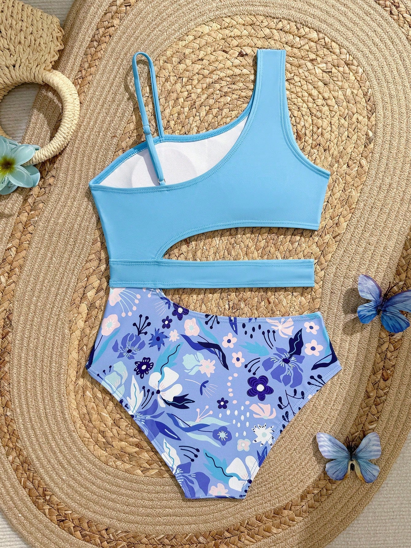 Purple tween girls one-piece swimsuit with asymmetrical neckline, cut-out waist, striped pattern, fitted silhouette, and lined body.