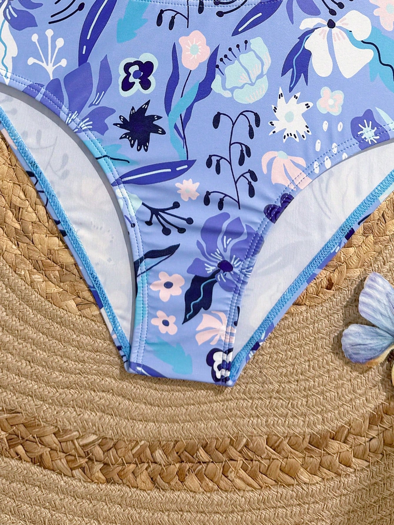 Purple tween girls one-piece swimsuit with asymmetrical neckline, cut-out waist, striped pattern, fitted silhouette, and lined body.