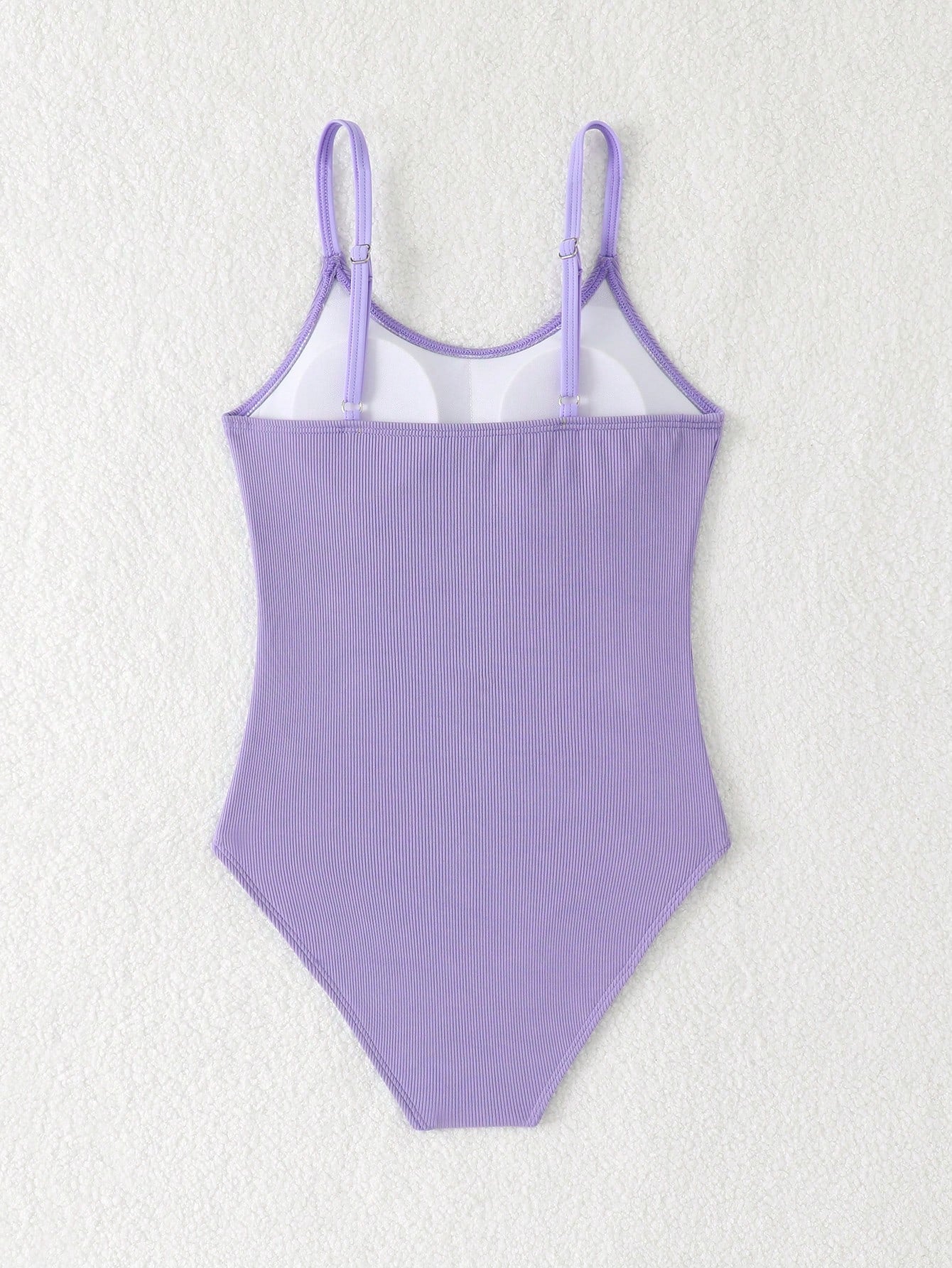 Purple rib knit one-piece swimsuit for tween girls with spaghetti straps, fitted shape, mid-waist bottom, wireless bra, and lined body.