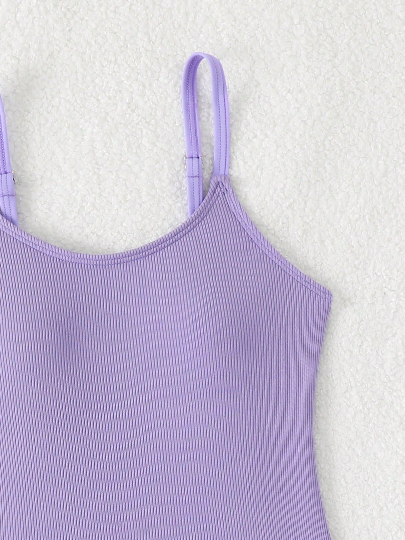Purple rib knit one-piece swimsuit for tween girls with spaghetti straps, fitted shape, mid-waist bottom, wireless bra, and lined body.