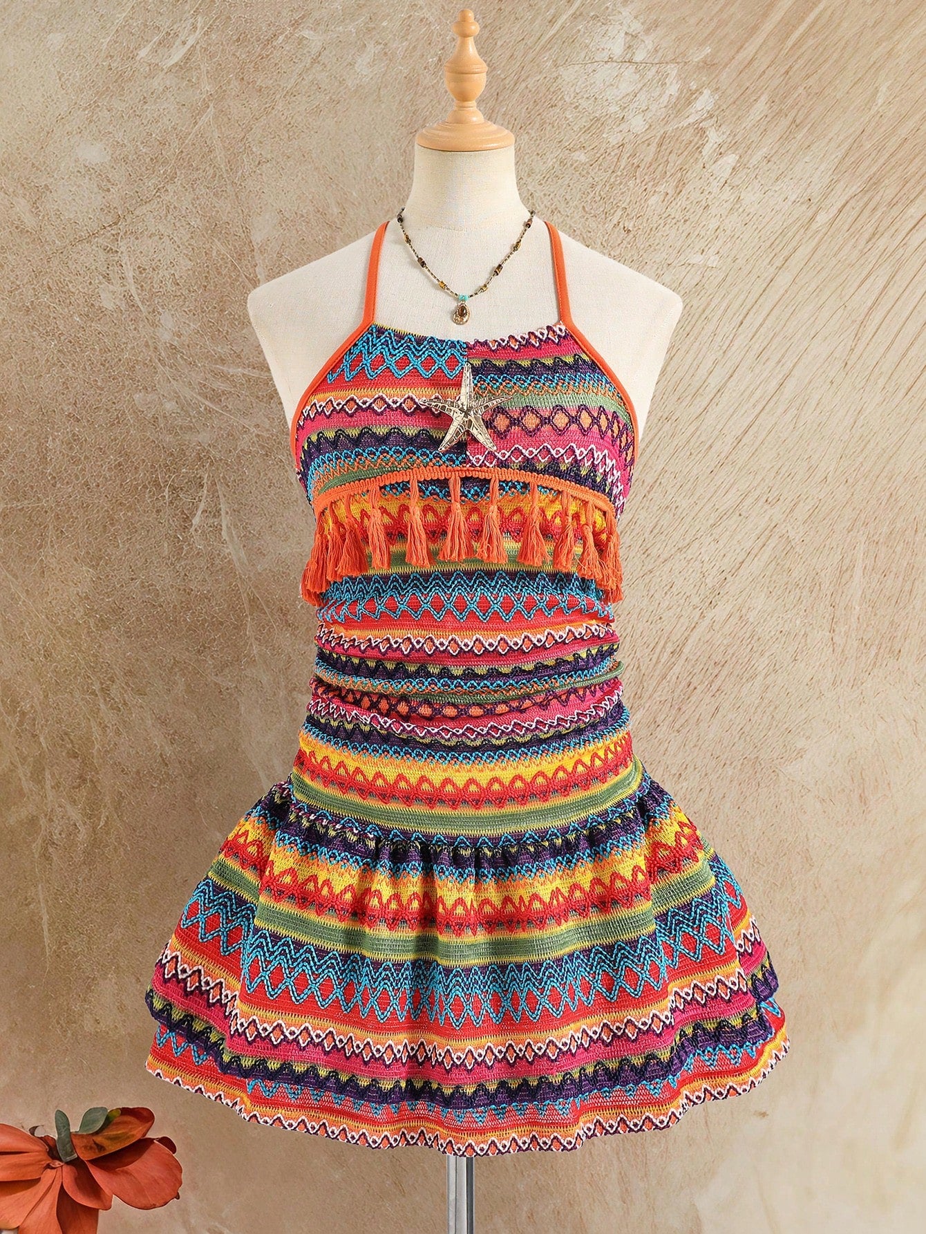 Tween girls apricot sleeveless halter mini dress with textured starfish and shell decor, shirred tiered layer, high waist, and flounce hem.