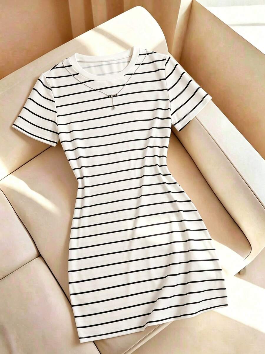 Girls black striped midi dress featuring short sleeves, round neck, slim fit, and flared hem.