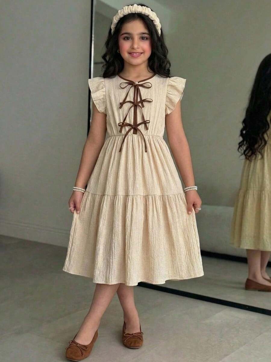 Apricot striped tween girl midi dress with flounce short sleeves, round neckline, high-waist belt, and layered ruffle hem.