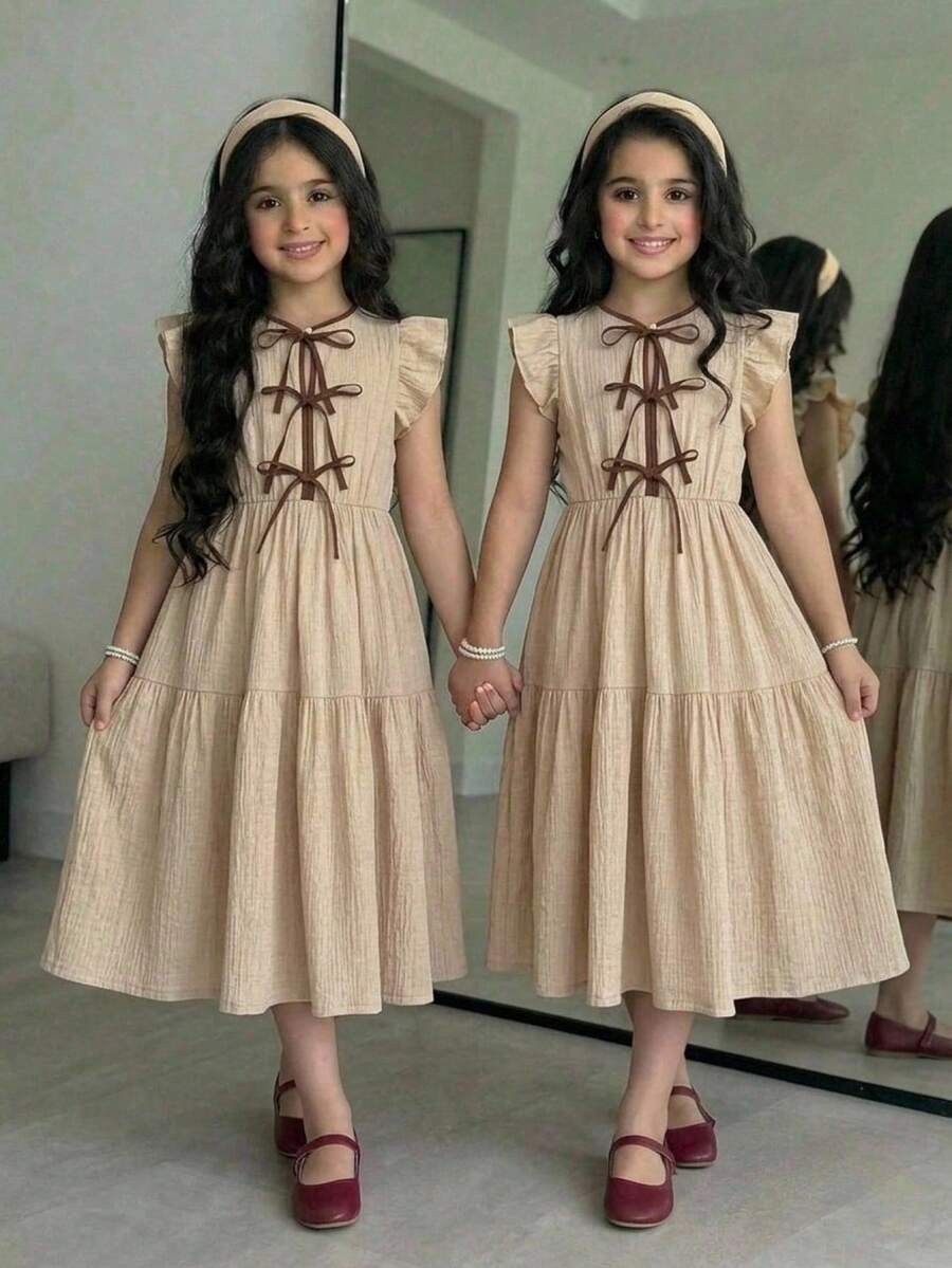 Apricot striped tween girl midi dress with flounce short sleeves, round neckline, high-waist belt, and layered ruffle hem.