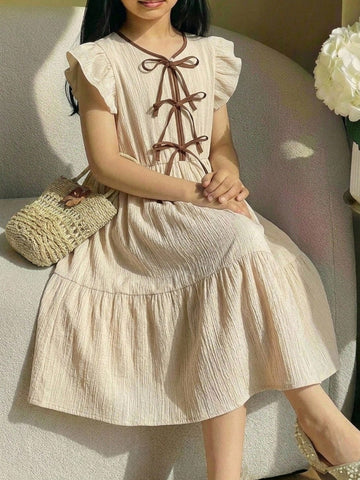 Apricot striped tween girl midi dress with flounce short sleeves, round neckline, high-waist belt, and layered ruffle hem.
