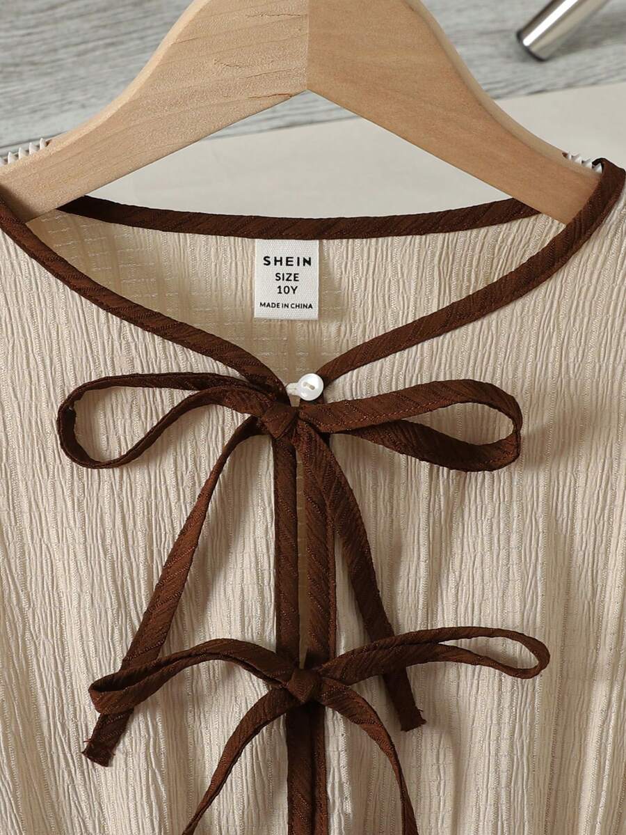Apricot striped tween girl midi dress with flounce short sleeves, round neckline, high-waist belt, and layered ruffle hem.
