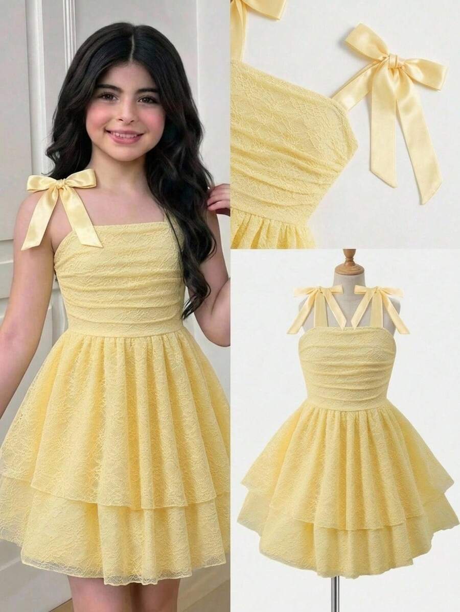 Tween girl wearing a pink tiered off-the-shoulder midi dress with shirred high waist and layered hem