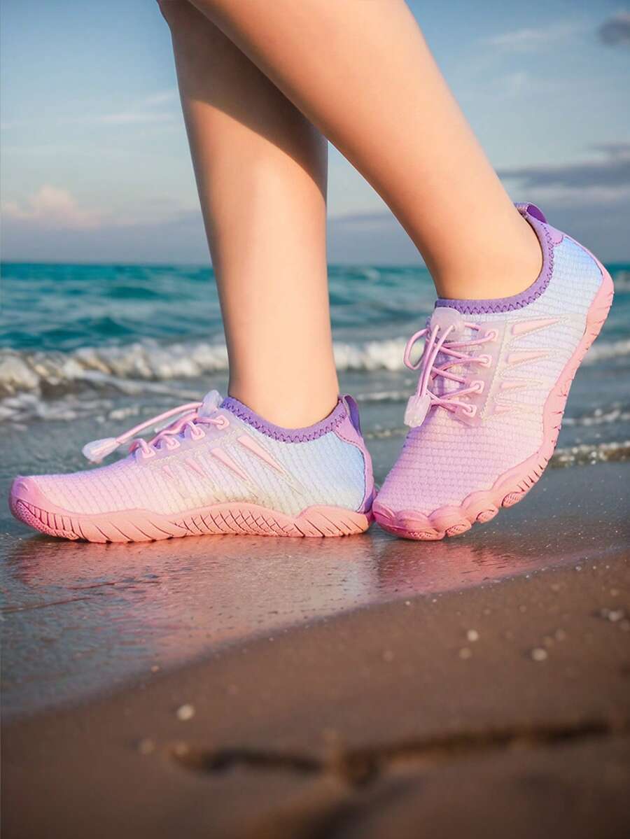Baby pink girls' water shoes with lace-up design and non-slip rubber outsole for beach and outdoor sports.