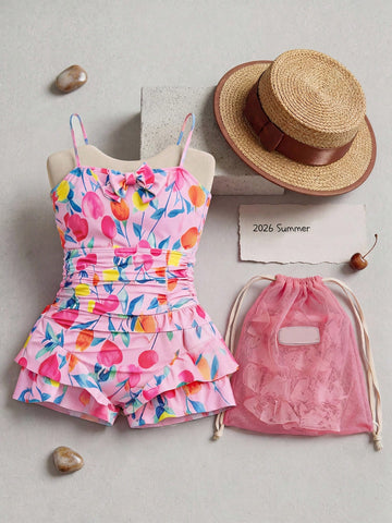 Pink one-piece swimsuit for tween girls with ruffle details, spaghetti straps, all-over print, and mid-waist bottom