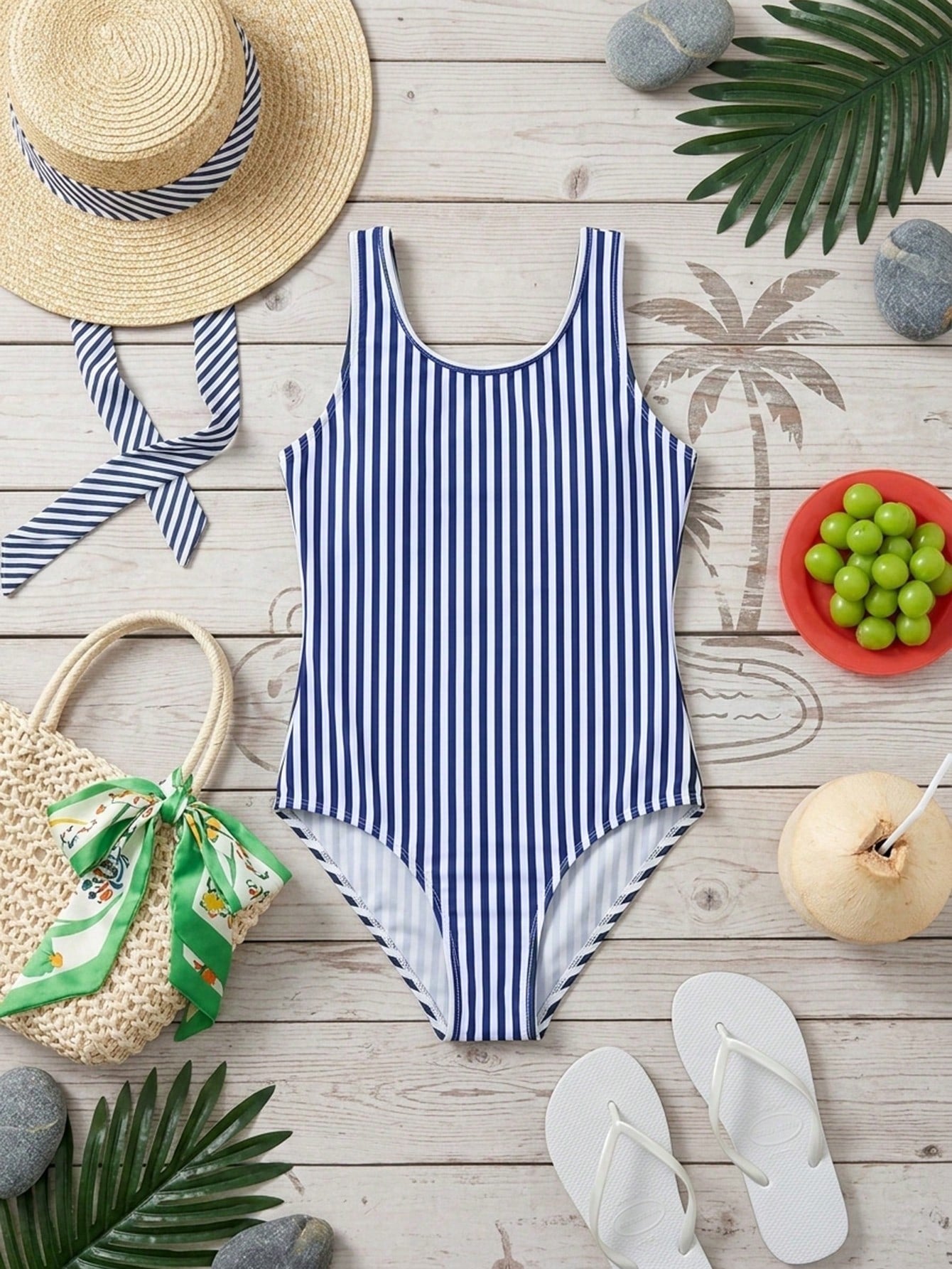 Blue and white striped one-piece swimsuit for tween girls with high neck, button detail, fitted shape, and mid-waist bottom for vacation swimwear
