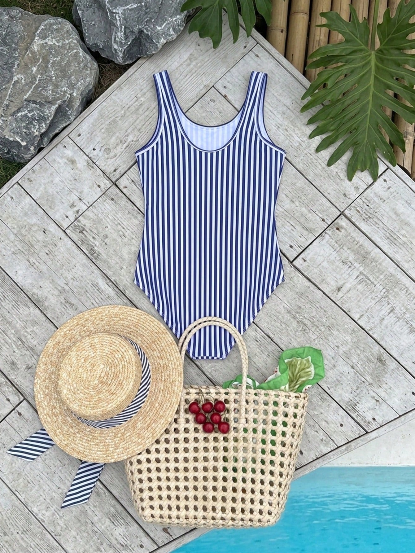Blue and white striped one-piece swimsuit for tween girls with high neck, button detail, fitted shape, and mid-waist bottom for vacation swimwear