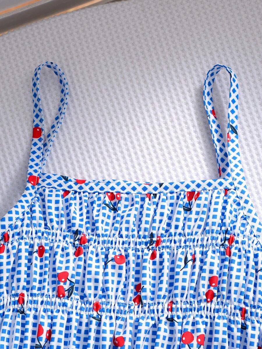 Girls 2-piece summer outfit set featuring a blue bow print camisole top with spaghetti straps and matching high-waisted straight leg pants.