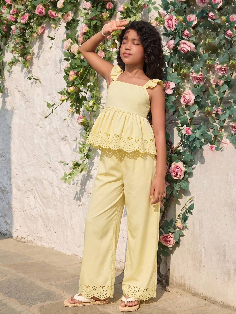 Tween girl wearing an apricot 2-piece outfit set featuring a shirred spaghetti strap short cami top and matching wide-leg long pants.