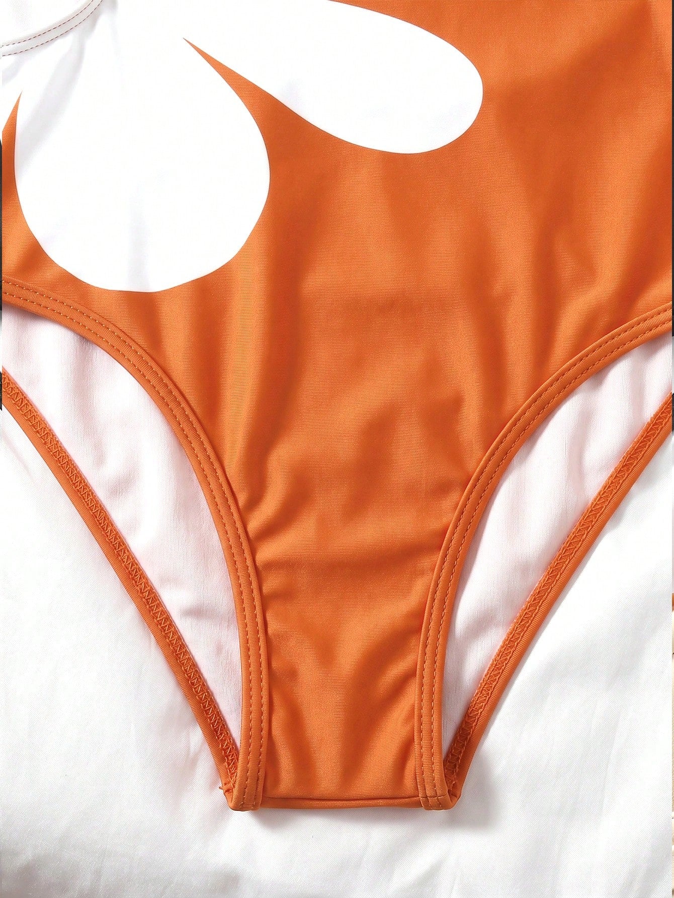 Tween girls' black and white one-piece swimsuit with striped patchwork design, scoop neck, asymmetrical cut-out detail, and fitted vacation swimwear style.