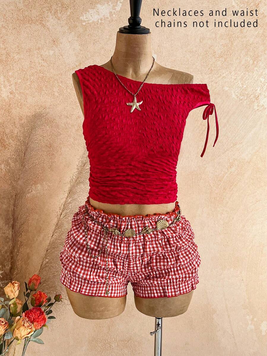 Tween girl wearing a casual 2-piece set featuring a black rib-knit scoop neck tank top and leopard print paperbag waist shorts with a matching belt.