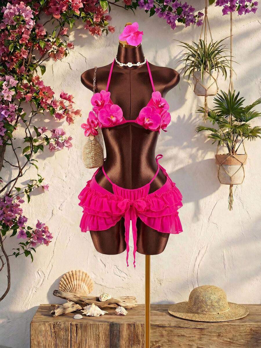 Women's 3-piece blue bikini swimwear set featuring a crop top with 3D rose accents, tie back detail, spaghetti straps, and tie-side bottoms.