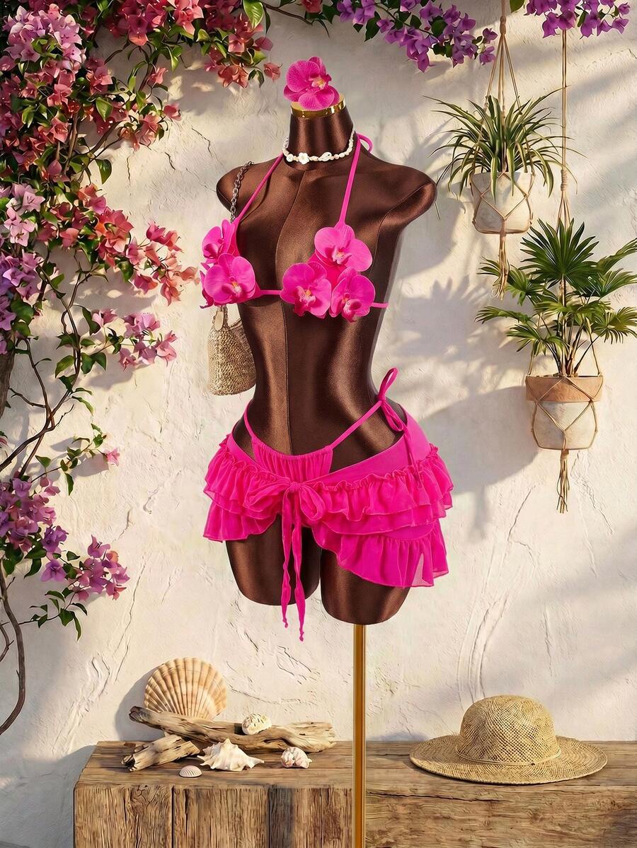 Women's 3-piece blue bikini swimwear set featuring a crop top with 3D rose accents, tie back detail, spaghetti straps, and tie-side bottoms.