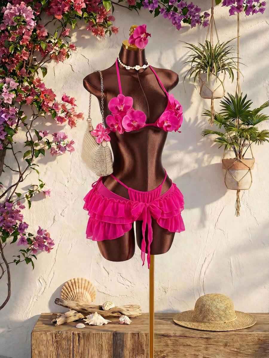 Women's 3-piece blue bikini swimwear set featuring a crop top with 3D rose accents, tie back detail, spaghetti straps, and tie-side bottoms.
