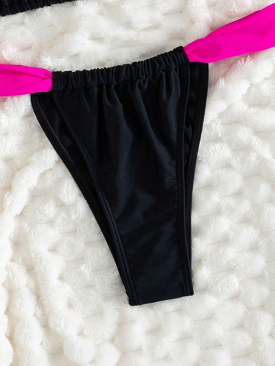 Women's striped halter two-piece swimsuit featuring a lace-up triangle top with removable padding and high-cut low-waist bikini bottoms.