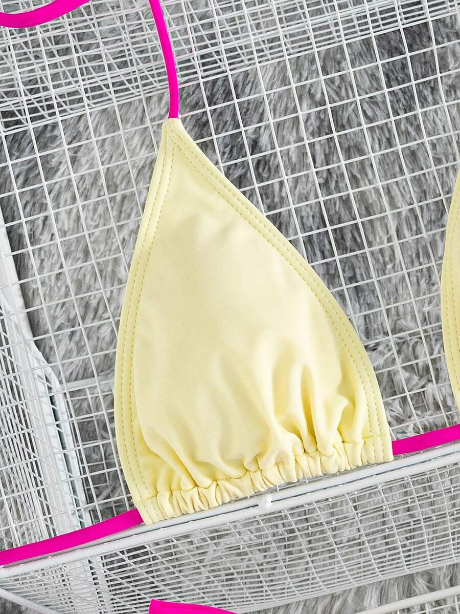 Women's striped halter two-piece swimsuit featuring a lace-up triangle top with removable padding and high-cut low-waist bikini bottoms.