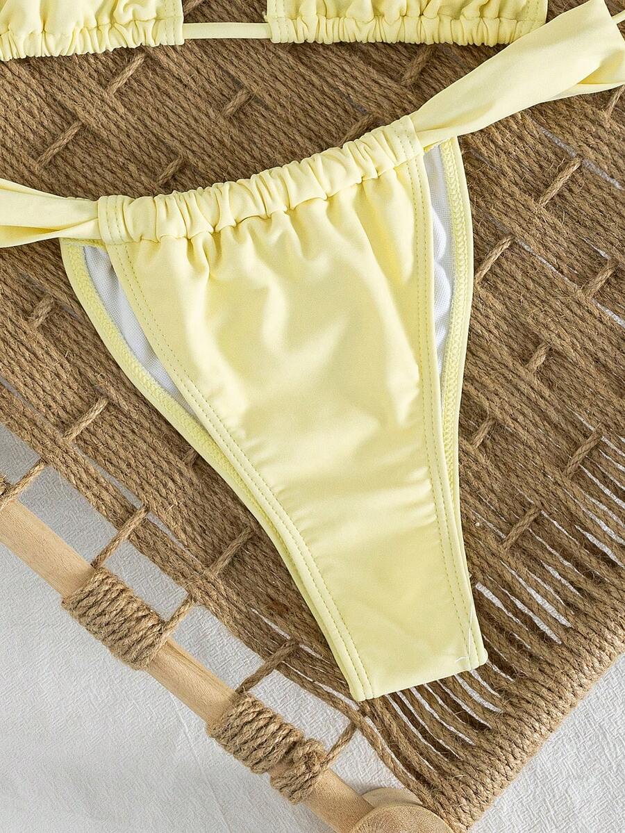 Women's striped halter two-piece swimsuit featuring a lace-up triangle top with removable padding and high-cut low-waist bikini bottoms.