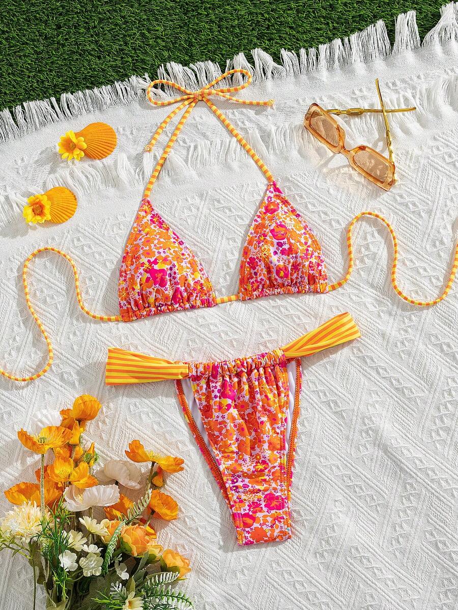 Women's striped halter two-piece swimsuit featuring a lace-up triangle top with removable padding and high-cut low-waist bikini bottoms.